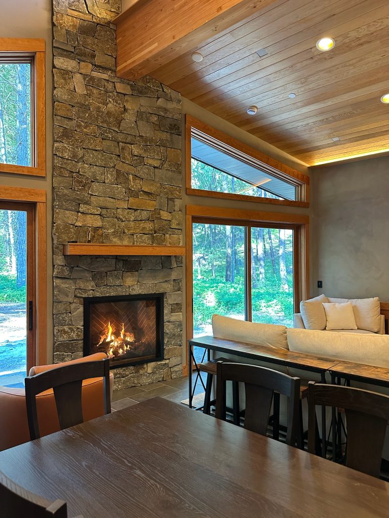 Mazama cabin rental featuring a large stone gas fireplace, perfect for cozy evenings in a mountain retreat.