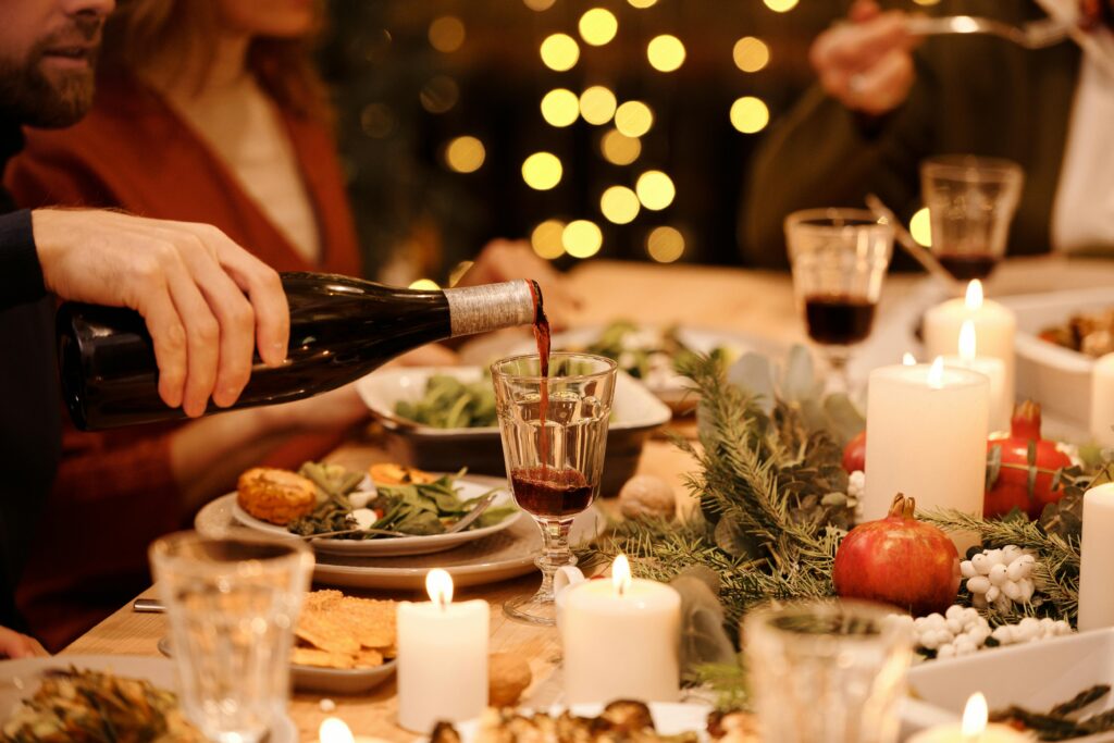 Couples enjoying a festive Christmas dinner together at a dining table in a cozy cabin