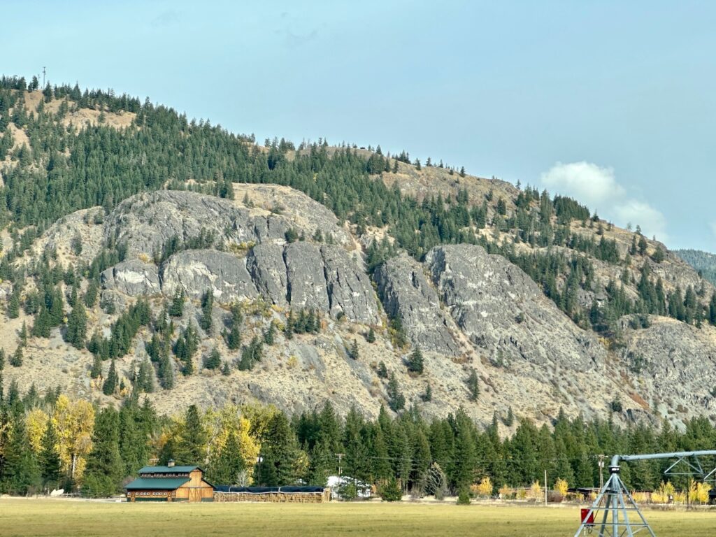 Farm fields with a rustic barn and colorful fall trees near Mazama’s Flagg Mountain