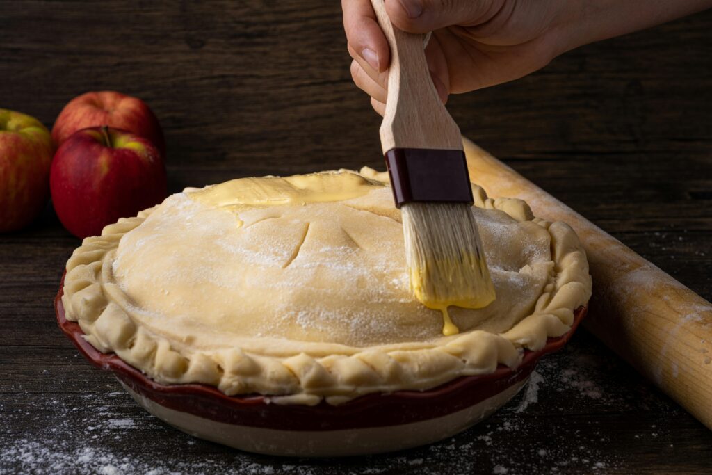 Friend baking a homemade pie in the kitchen at Pinehaven cabin
