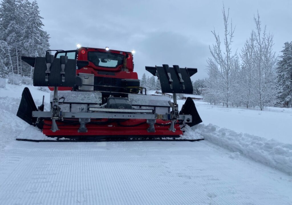 Trail groomer creating perfectly groomed tracks on a snowy Methow Valley ski trail