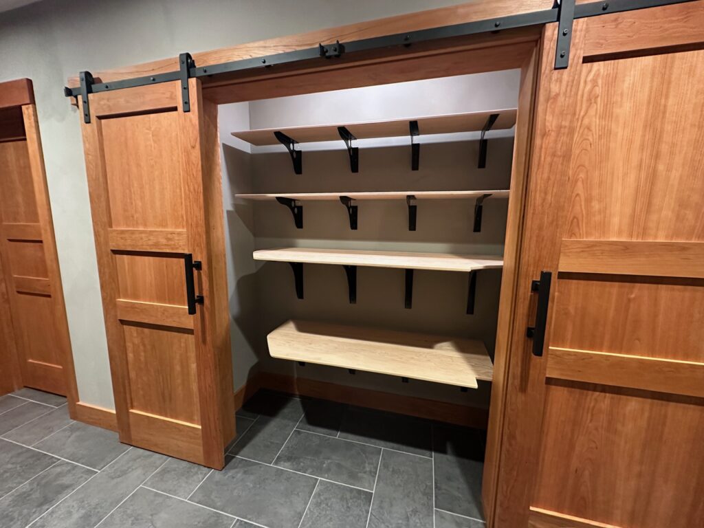 Spacious pantry at Pinehaven cabin with ample shelves for food and travel boxes