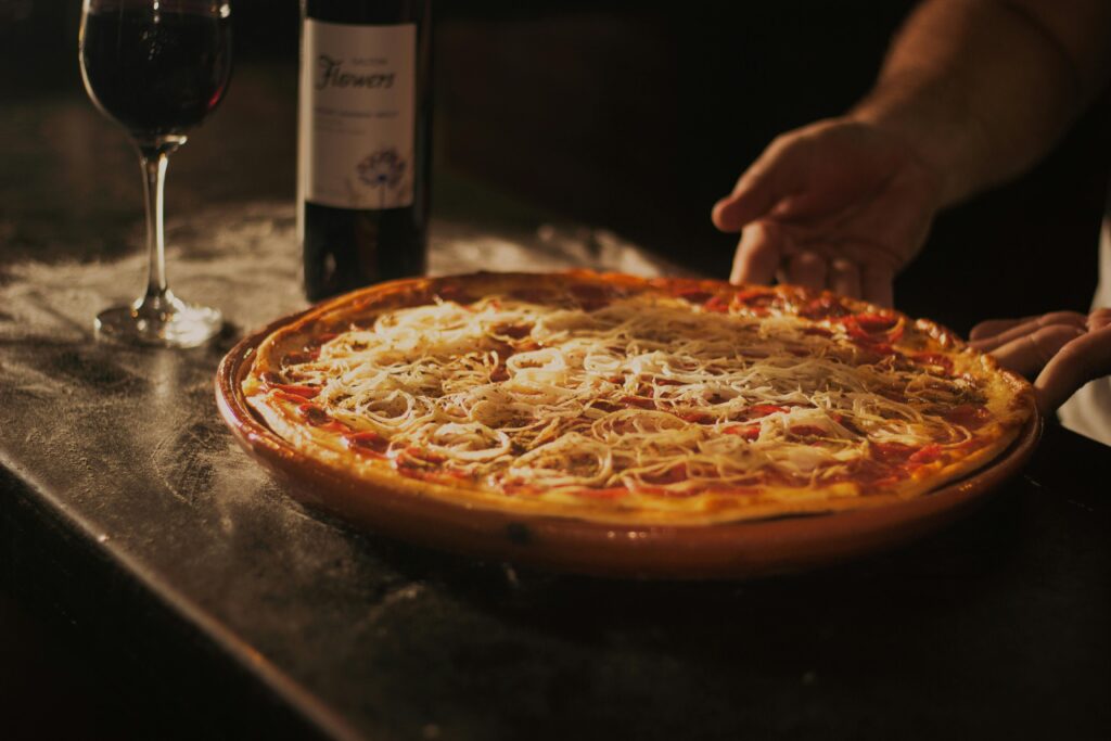 Freshly baked wood-fired pizza with red wine at Woodstone Pizzeria in Mazama