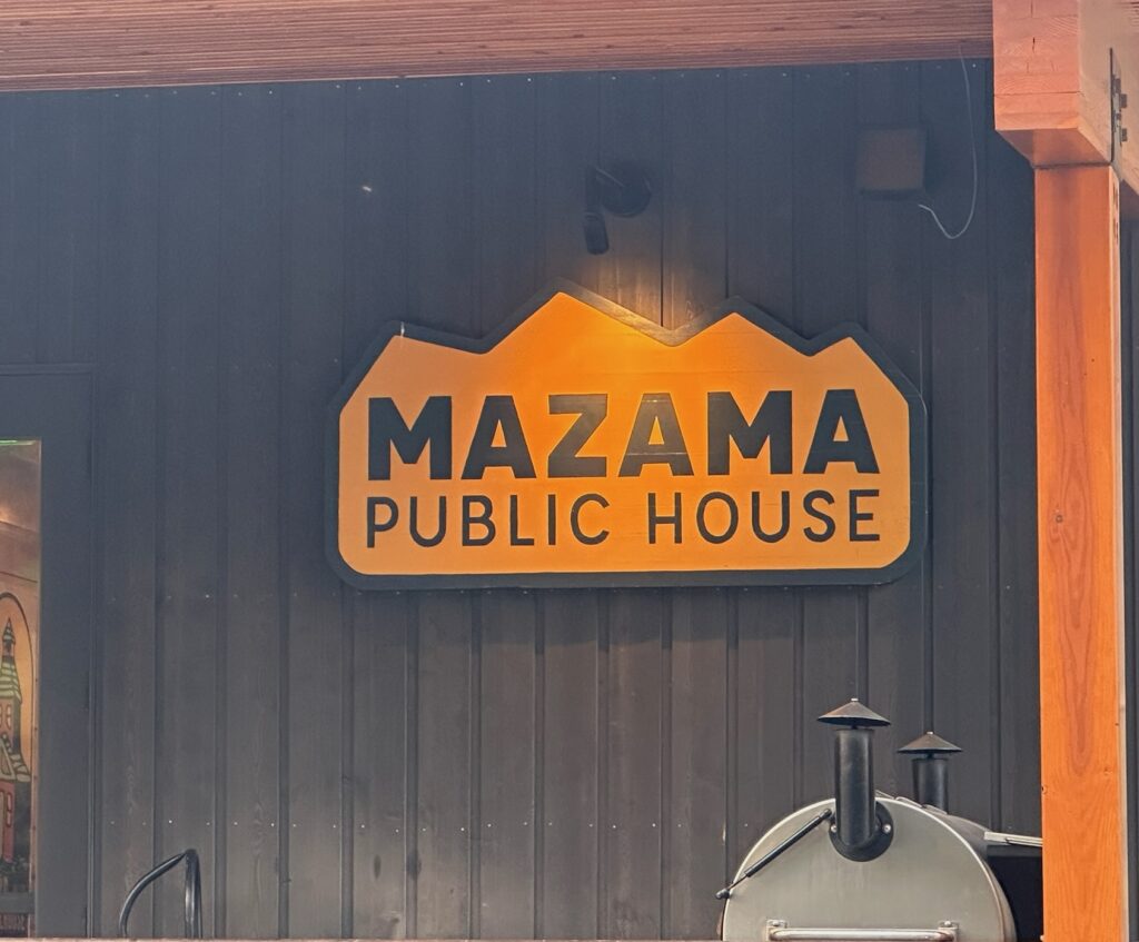 Mazama Public House in Mazama, Washington, with guests dining outdoors under string lights.
